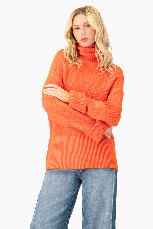 Suéter tejido oversized naranja con cuello tortuga y patrón geométrico